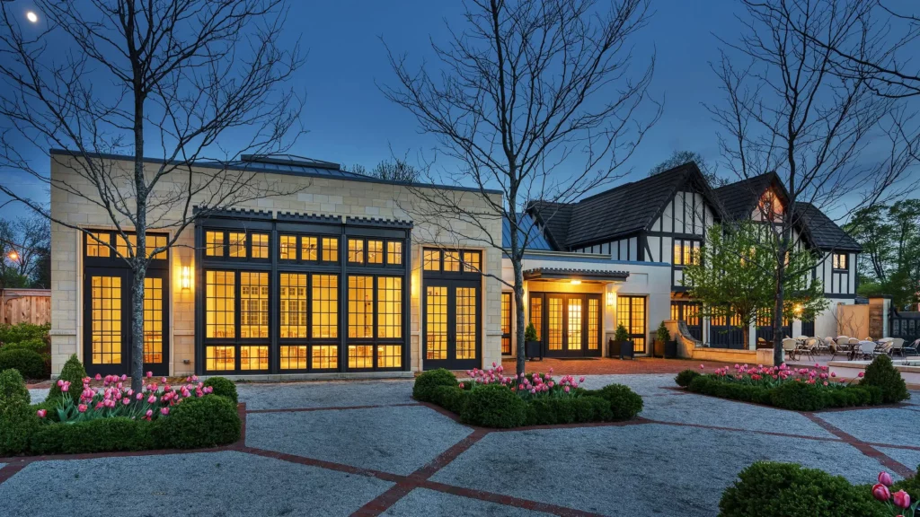 The Conservatory in the evening time, featuring tall windows overlooking the courtyard and Formal Garden.