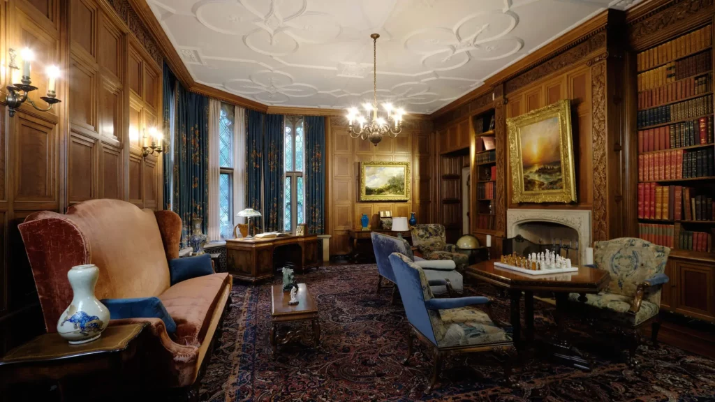 The Library features a plaster ceiling decorated in rose and unvarnished, walnut paneling.