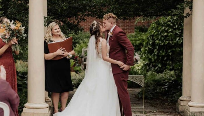 A bride and groom kiss in the Ceremony Garden. 