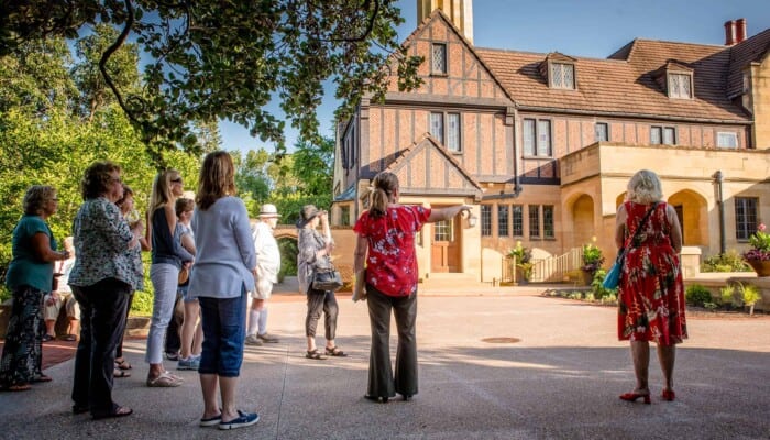 A group of people tour a garden area.