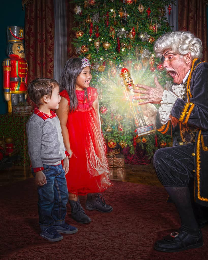 Drosselmeyer shows two children a toy nutcracker.