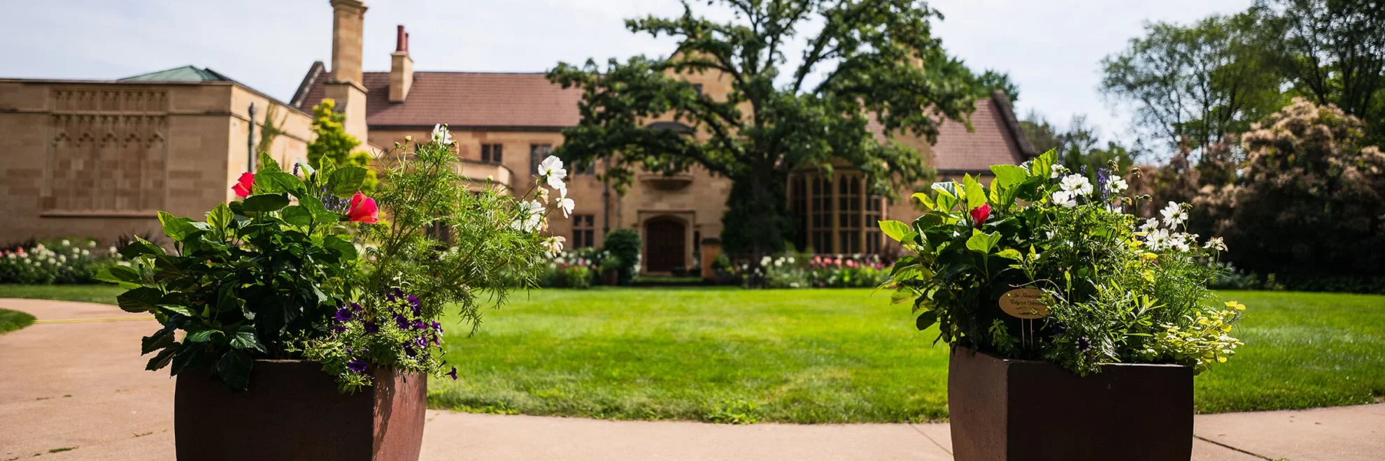 The entrance to the Paine estate, with planters at forefront and the mansion in the background.