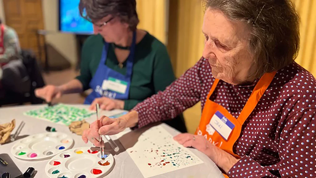 Two SPARK! participants create watercolor paintings