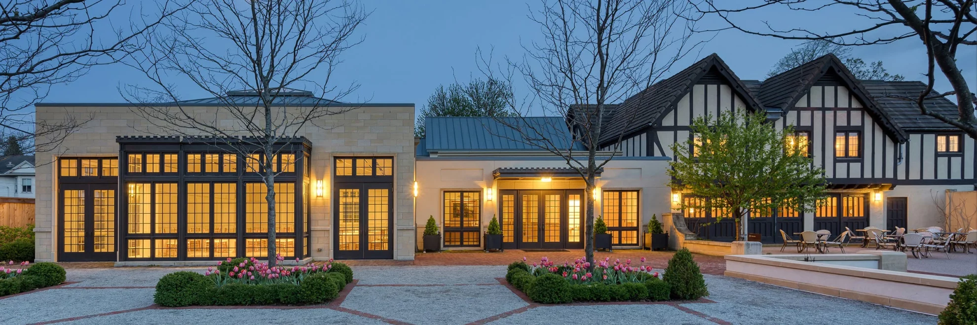 The Conservatory and Carriage House in the evening time in spring.