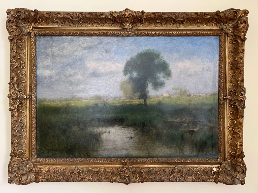 An oil painting of a pond and grassy field in spring, with a tree in the background, light blue skies, and puffy clouds.