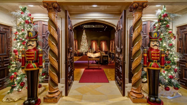 The Main Gallery and foyer during Nutcracker in the Castle, with life-size Nutcrackers, Christmas trees, and a room decorated in the background.