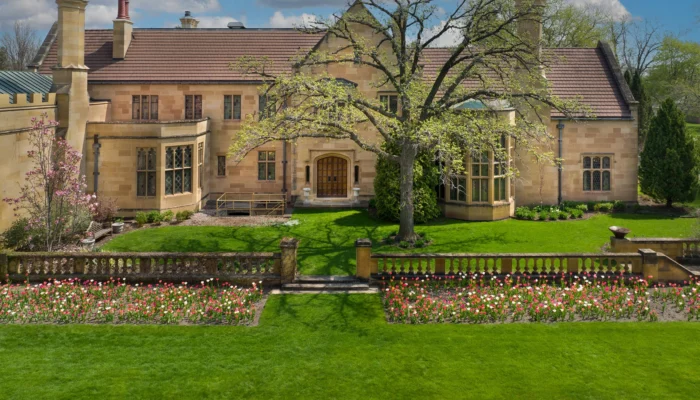 An aerial view of the mansion façade with colorful tulips in spring.