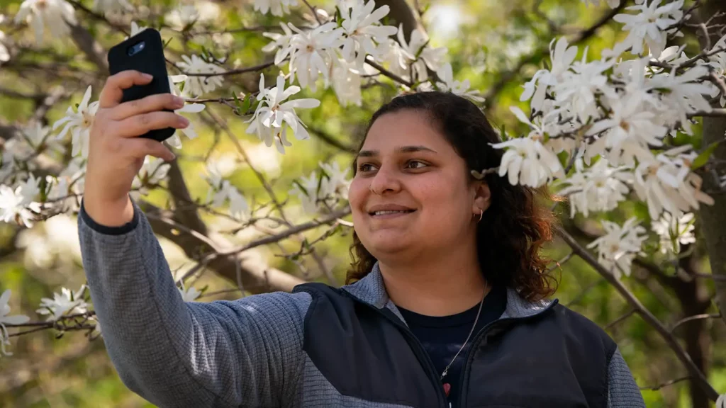 A girl takes a selfie in the gardens.