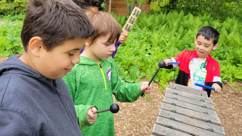 Young boys play with musical toys in the Children's Garden.