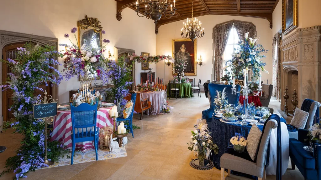 Six elaborate, floral table settings embellish the Great Hall.