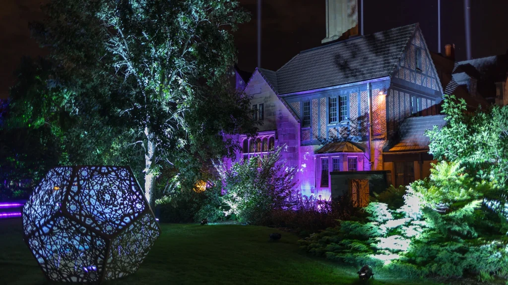 The Paine mansion illuminated at night.