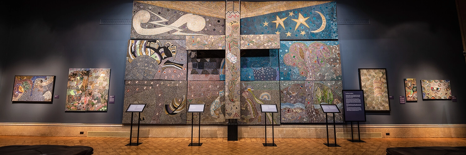 A multi-panel, large multicolor beaded artwork with a large cross at center titled “African Crucifixion.”