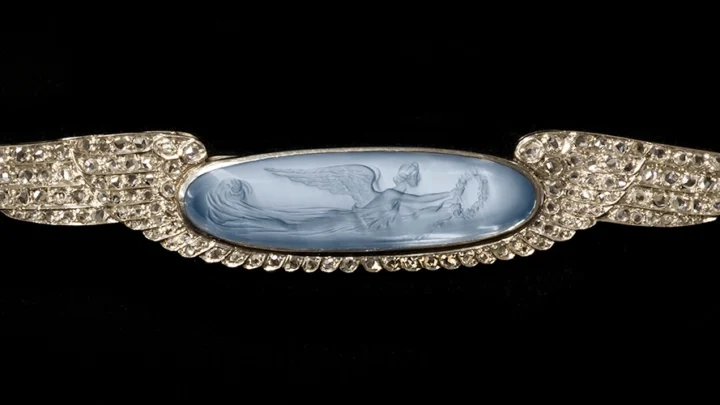 13. Mrs. W.H. (Elinor) Klapp, Brooch, c. 1895-1914. Carved moonstone, silver or platinum. Collection of the Bronson Family. Photograph by Firestone and Parson.