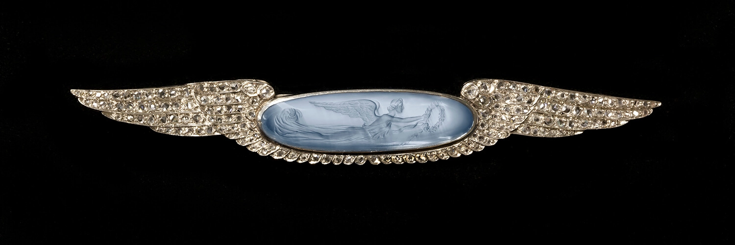 13. Mrs. W.H. (Elinor) Klapp, Brooch, c. 1895-1914. Carved moonstone, silver or platinum. Collection of the Bronson Family. Photograph by Firestone and Parson.