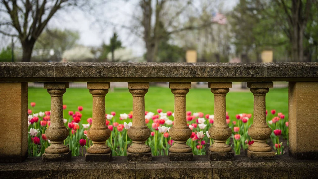 Pink and white tulips in the front of the mansion.