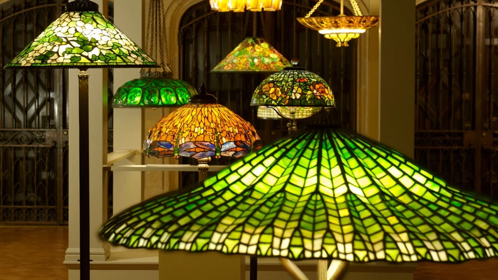 A variety of Tiffany lamps and chandeliers on display.