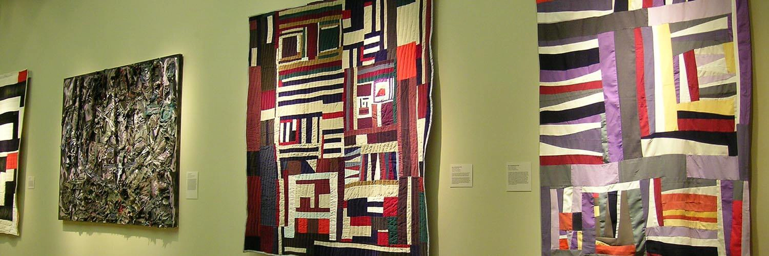 Brightly colored quilts on view in the main gallery.