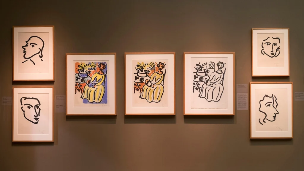 Artworks by Henri Matisse hang on a wall.