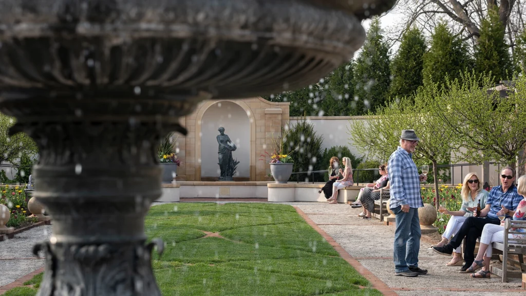 Paine members chat in the Formal Garden in spring.