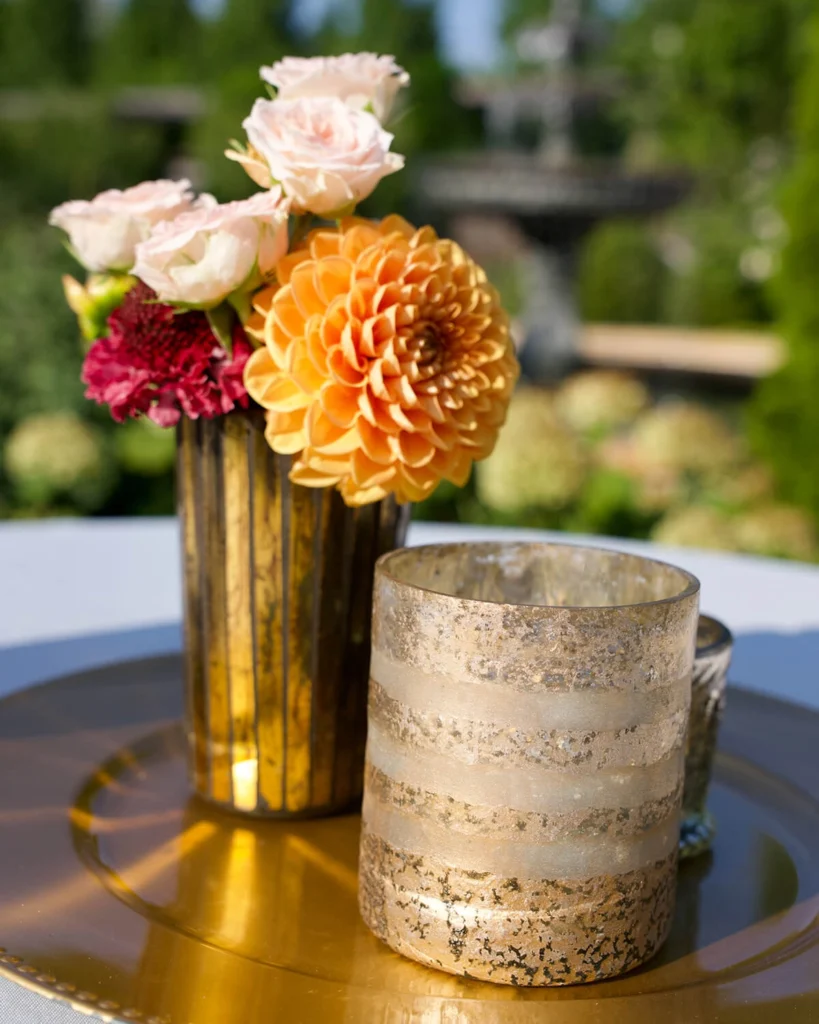 Florals in a vase with a candle.