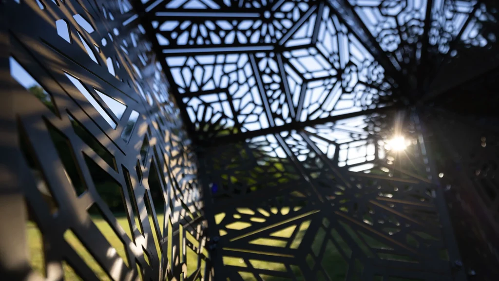 An up-close look at the cuts of a metal geometric sculpture.