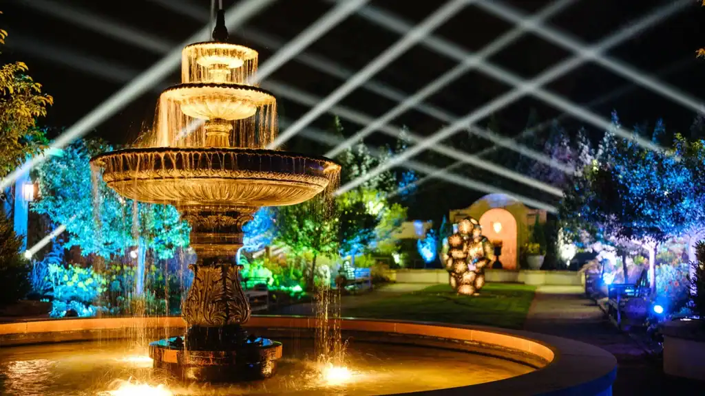 An illuminated garden, sculpture, and fountain featured in The Nature of Light.