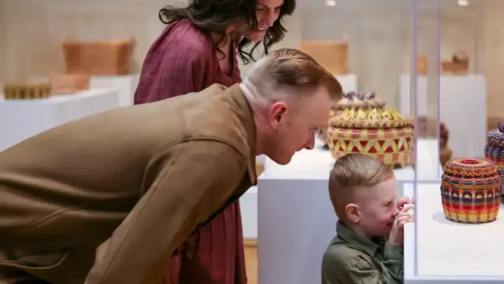 A family views an art exhibition