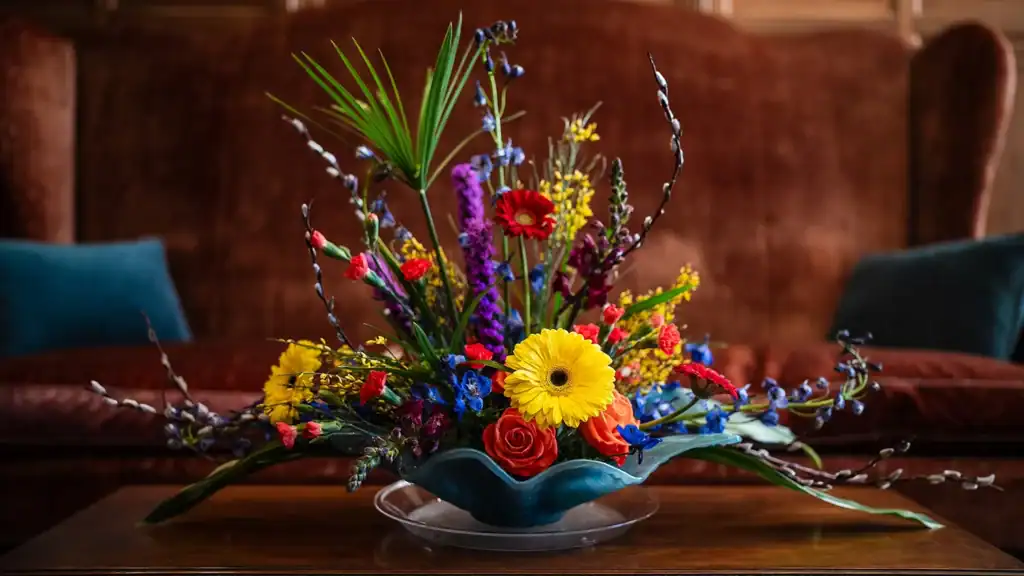 A colorful arrangement of flowers on a coffee table.