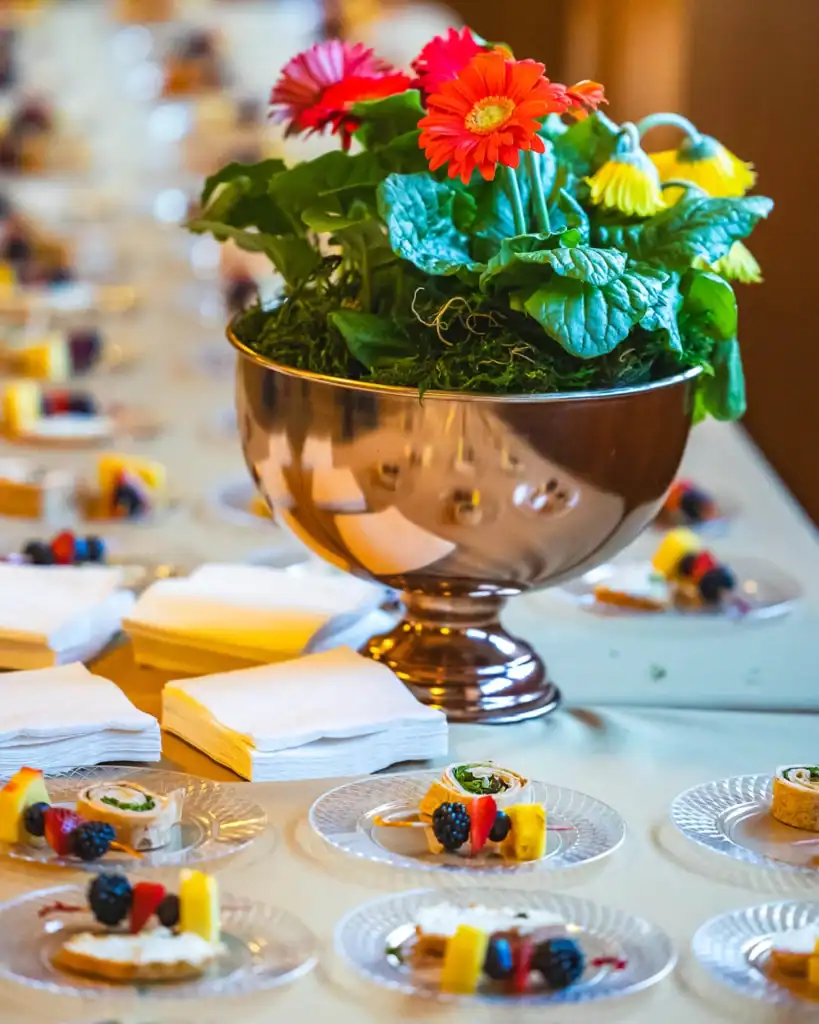 Tea time treats on a table with a floral display