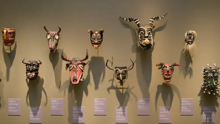 Mexican masks on view for "Dancing with Life: Mexican Masks" in the main gallery.