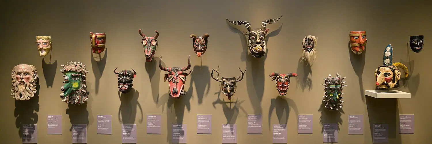 Mexican masks on view for "Dancing with Life: Mexican Masks" in the main gallery.