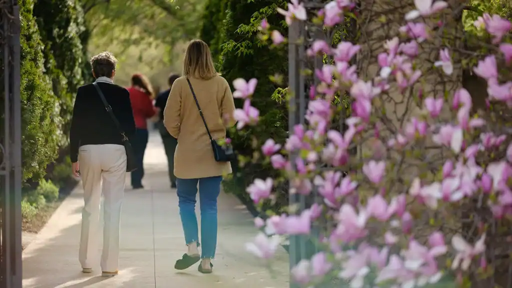 Two women walk in the Paine gardens