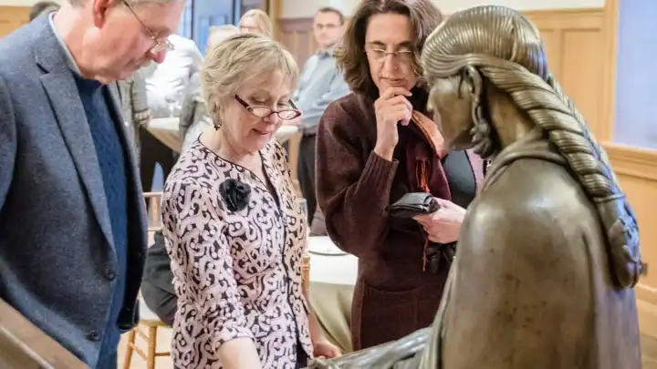 Paine Members view a sculpture up close