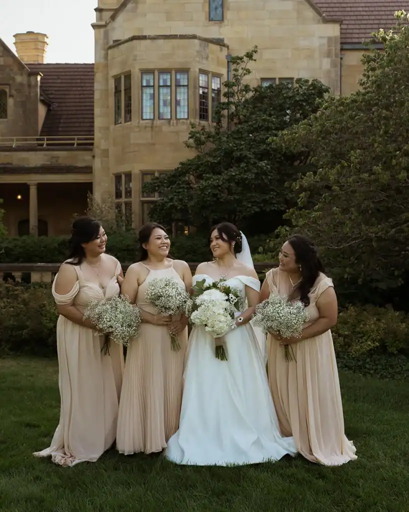 A bride and her bridesmaids pose for a photo.