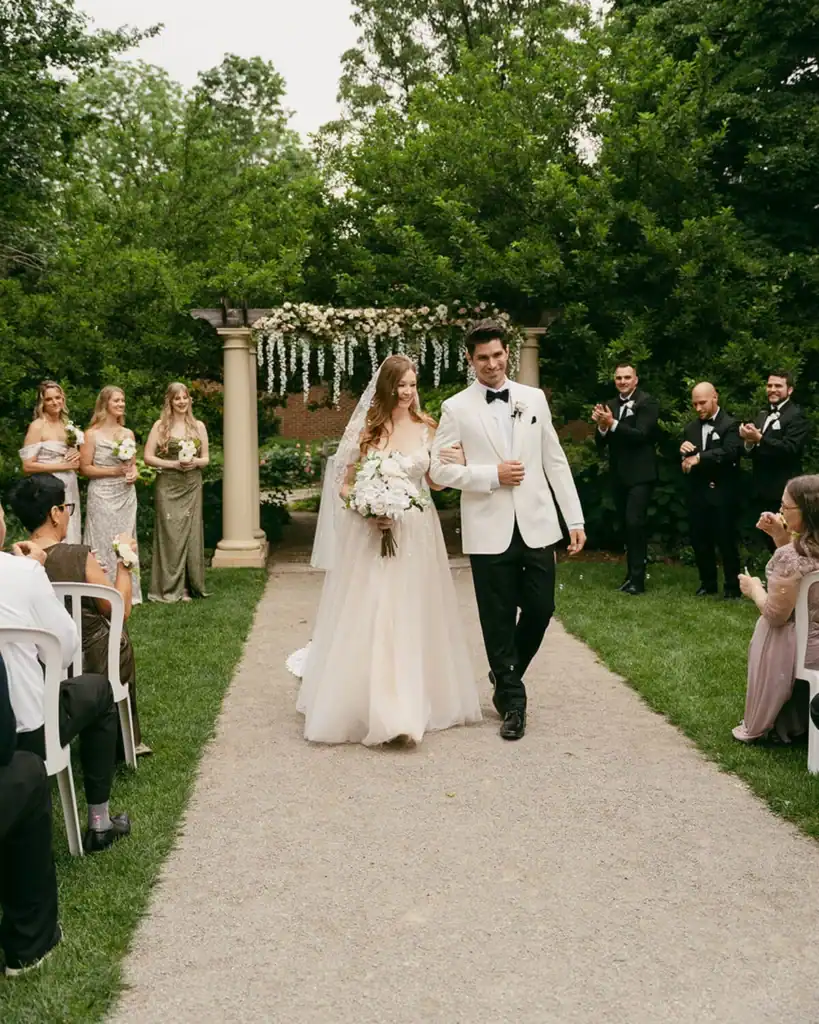 A couple walks down the aisle.