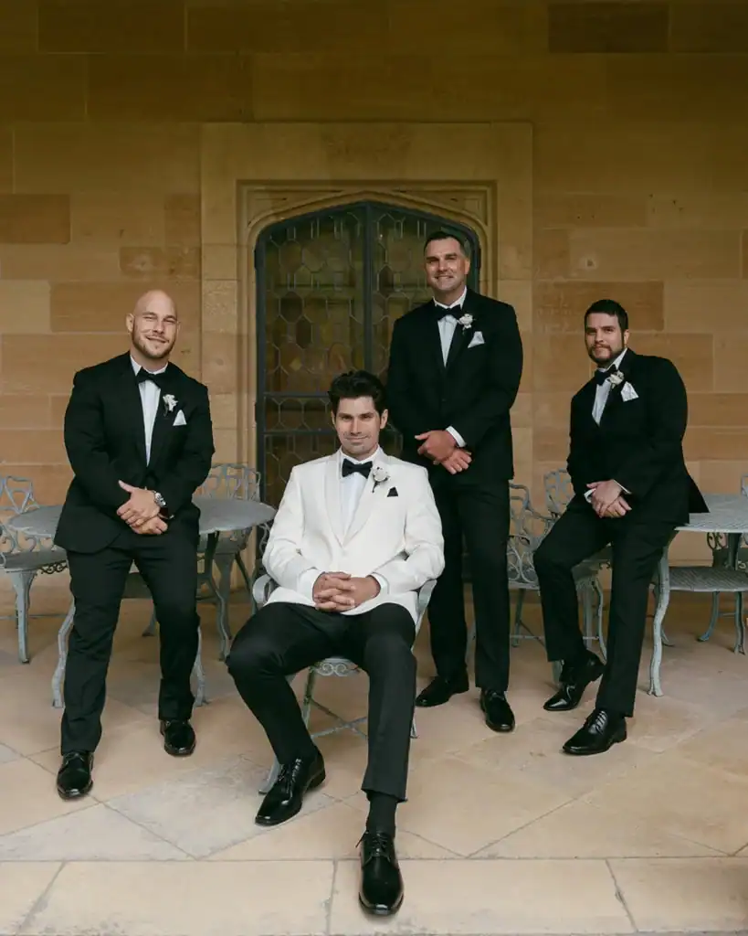 A groom and his groomsmen pose for a photo